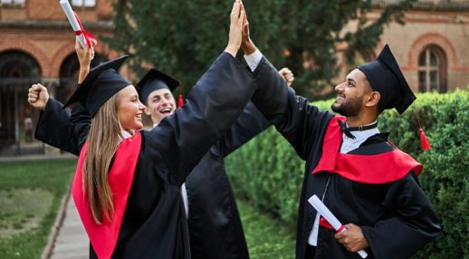 Three happy international graduate friends greeting in universit